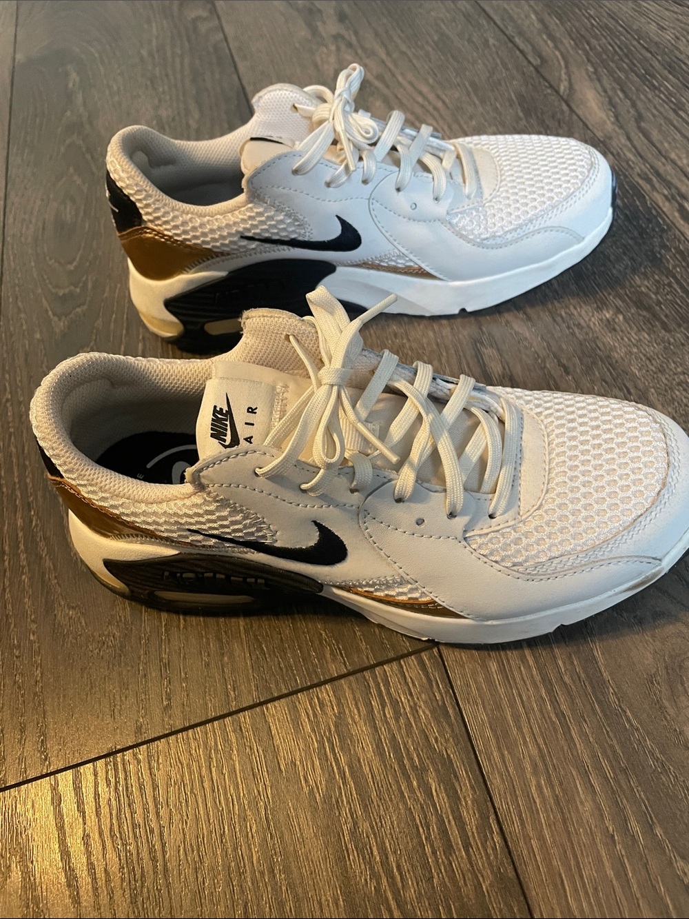 Nike women’s White Sneakers with Black & Gold Accents